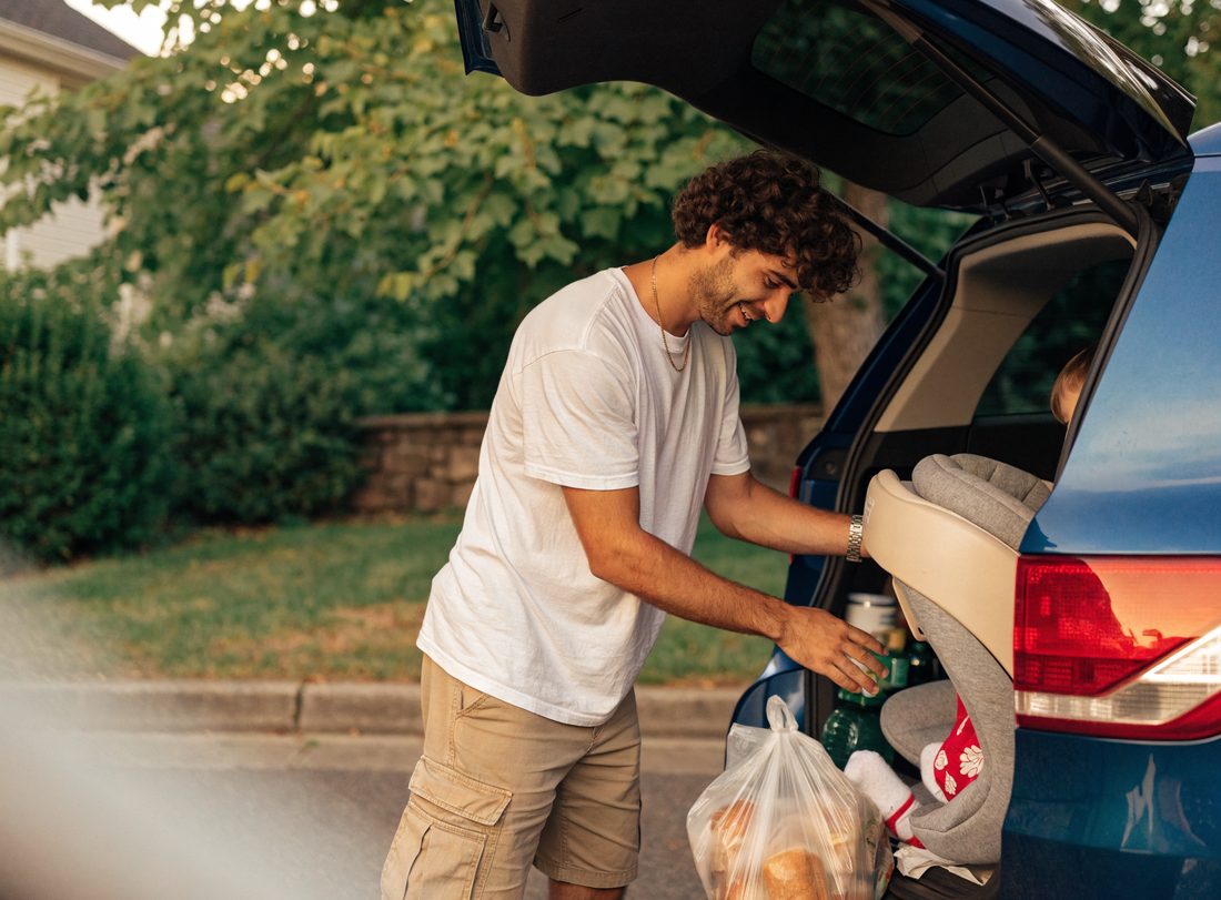 A customer loading their family SUV at home